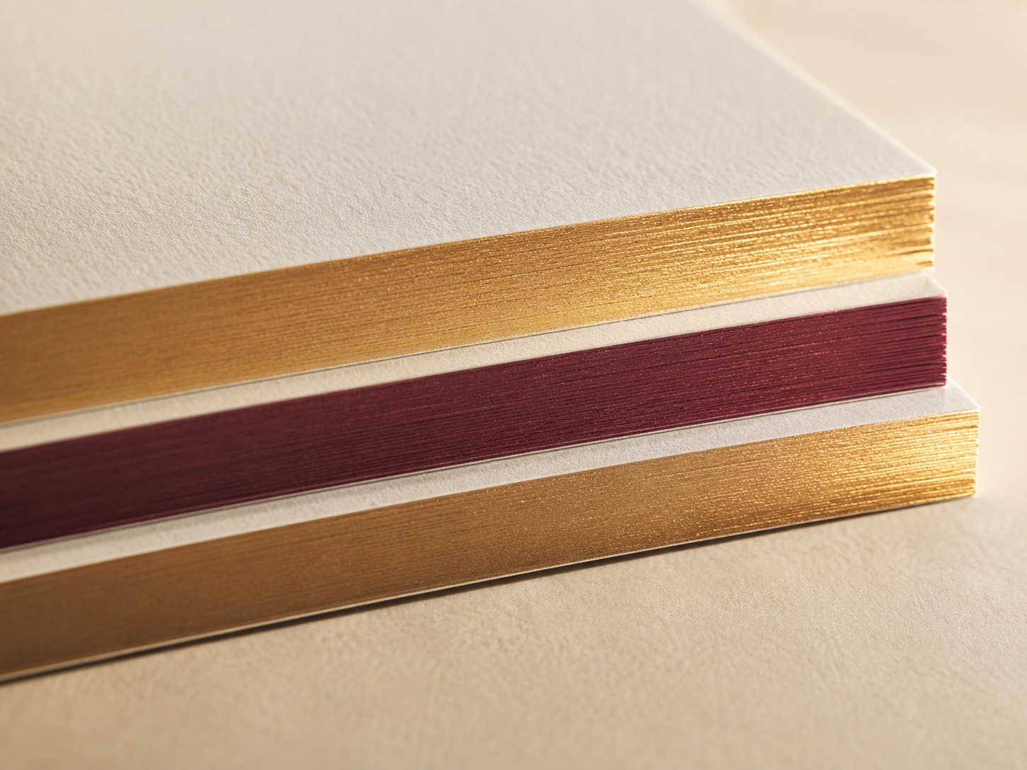 Layered cotton card stock with gold and oxblood edge finishing