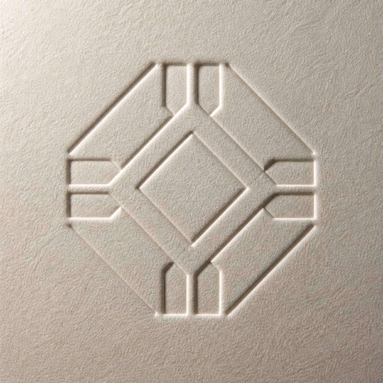 Close photographic detail of a blind embossed mark pressed into warm cotton card
